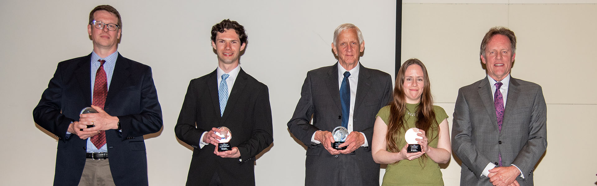 award winners on stage holding their awards