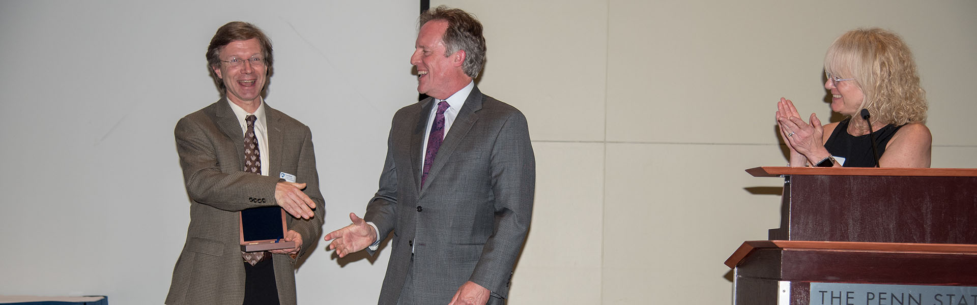 Ken laughing while accepting his award from Dean Kump