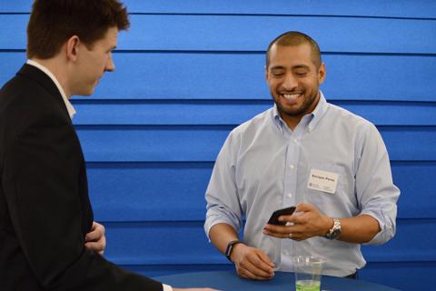 Alumnus Enrique Perez chats with a student