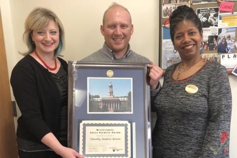 Leslie Laing, director for Penn State Adult Learner Programs and Services presents diploma case to OASA Recipient Timothy Bowen