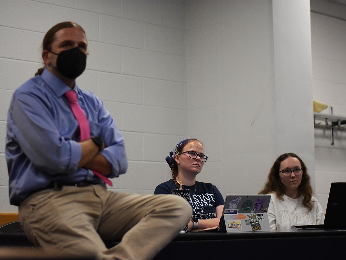 Chris Fowler, associate professor of geography, and students Clarissa Styer and Aunica Groh listen to Gov. Tom Wolf discuss the redistricting process
