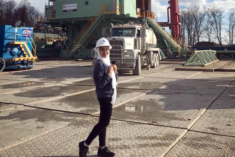 Maram Ejaimi, a senior majoring in petroleum and natural gas engineering, tours an oil well 